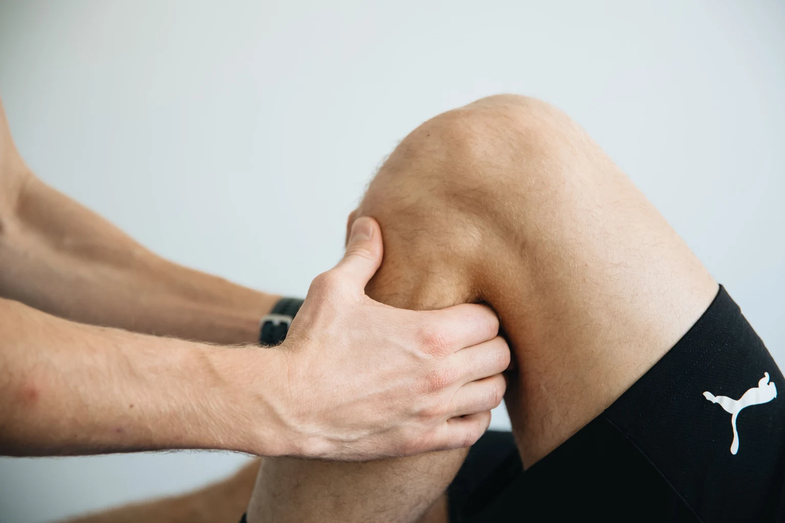 Close-up of a physiotherapist working on a patient’s knee